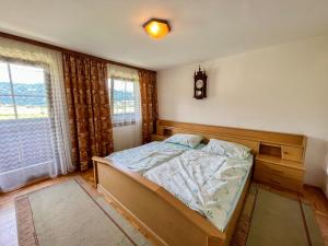 a bedroom with a bed and a clock on the wall at Holiday Home Lama by Interhome in Niederwölz