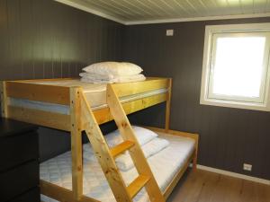 a bunk bed in a room with a window at Holiday Home Bjørkstue - SOW149 by Interhome in Fossdal