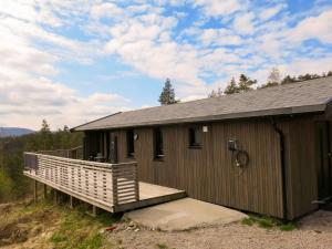 a wooden building with a large deck in front at Chalet Kosetoppen - SOW145 by Interhome in Fossdal