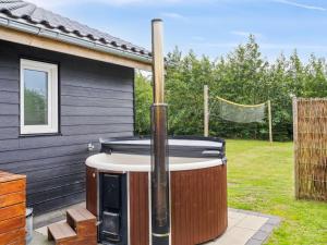 a hot tub sitting outside of a house at Holiday Home Ronia - 900m from the sea in Lolland- Falster and Mon by Interhome in Bøtø By