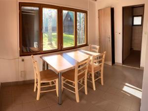 a dining room with a wooden table and chairs at Holiday Home Kemp Stříbrný rybník-2 by Interhome in Hradec Králové