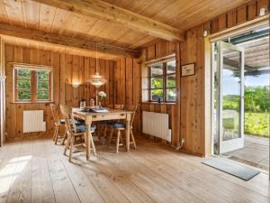 una sala da pranzo in legno con tavolo e sedie di Holiday Home Thana - 8km from the sea in Bornholm by Interhome a Gudhjem