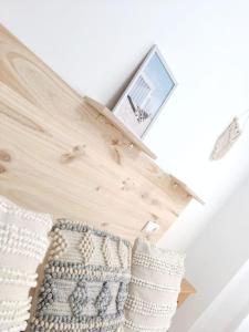 a room with a mirror and a pillow on a wall at Piso en Playa de Gandía! in Gandía +28 photos
