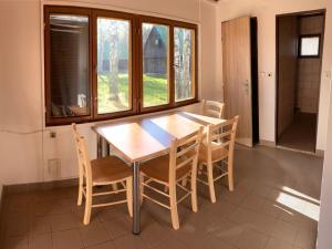 a dining room with a wooden table and chairs at Holiday Home Kemp Stříbrný rybník-14 by Interhome in Hradec Králové