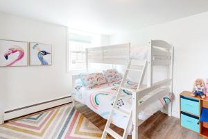 a bedroom with a bunk bed and a ladder at Riverside Retreat in Brockville