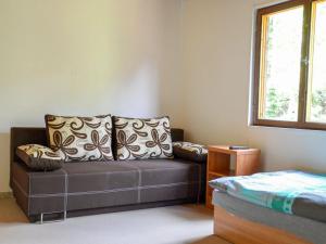 a living room with a couch and a window at Holiday Home Kemp Stříbrný rybník-13 by Interhome in Hradec Králové
