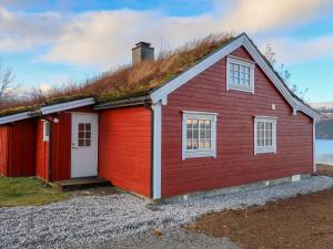 a red building with a grass roof at Chalet Krampehaugen - FJS046 by Interhome in Utvik