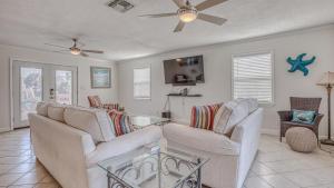 a living room with two couches and a ceiling fan at The Back Porch - Is a relaxing 4 bedroom 3 bathroom House on Holiday Isle in Destin