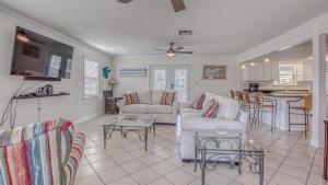 a living room with couches and a table at The Back Porch - Is a relaxing 4 bedroom 3 bathroom House on Holiday Isle in Destin