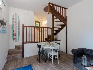 a dining room with a table and a staircase at Holiday Home La Cour du Moulin-6 by Interhome in Houlgate