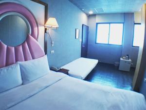 Postel nebo postele na pokoji v ubytování Fu Chia Hotel