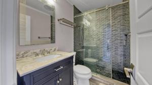 a bathroom with a toilet and a sink and a shower at Red Hot Retreat - Updated Holiday Isle Townhome on the Destin Harbor in Destin +38 photos