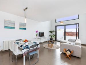 a living room with a table and a couch at Holiday Home Pijoan by Interhome in Sant Antoni de Calonge