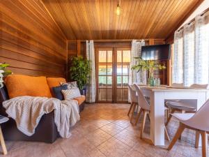 uma sala de estar com um sofá e uma mesa em Chalet Tropical 2 by Interhome em Riumar