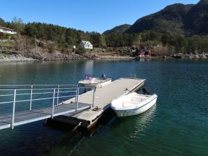 two boats are docked at a dock on a lake at Holiday Home Villa Hjartnes by Interhome in Hjartåker