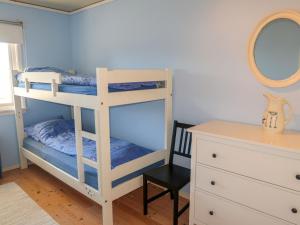 a bedroom with a bunk bed with a mirror and a chair at Holiday Home Villa Hjartnes by Interhome in Hjartåker +52 photos