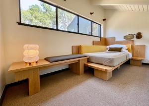 a bedroom with a bed and a bench and a window at Lodge At Marconi in Marshall