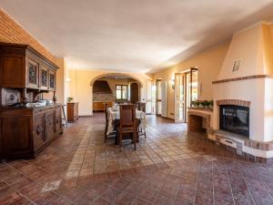 a large living room with a table and a fireplace at Holiday Home Lydia by Interhome in Mombaruzzo