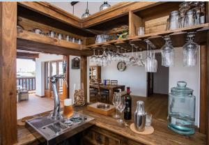 a kitchen with wooden cabinets and a counter top with wine glasses at Villa Casa Blanca in Playa Blanca