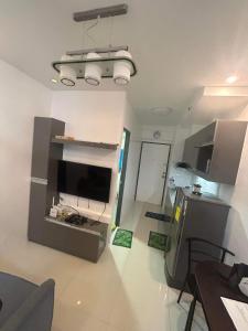 a room with a kitchen with a table and a refrigerator at Victoria Sports Tower in Manila