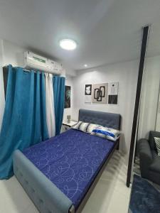 a bedroom with a blue bed with a blue canopy at Victoria Sports Tower in Manila