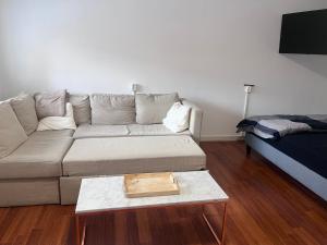 a living room with a couch and a coffee table at Family Studio-Barendrecht in Barendrecht