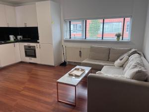 a living room with a couch and a table at Family Studio-Barendrecht in Barendrecht