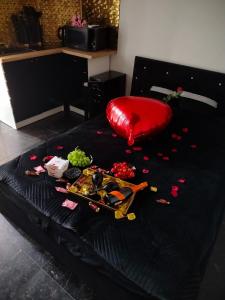 a black bed with a bunch of food on it at Apartament Czarny in Bydgoszcz