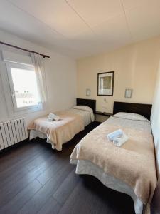 a bedroom with two beds and a window at Hotel Alegret in Tremp