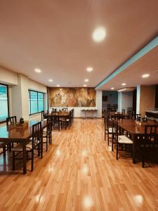 a dining room with wooden floors and tables and chairs at Hotel Alegret in Tremp