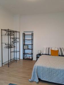 a bedroom with a bed and two shelving at Velbert am Berg in Velbert