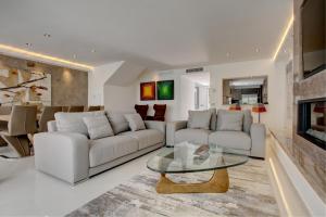 a living room with white furniture and a fireplace at Casa Stefania in Marbella
