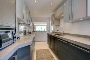 a kitchen with stainless steel appliances and a microwave at Casa Stefania in Marbella