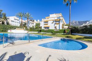 a swimming pool in front of a building at Casa Stefania in Marbella