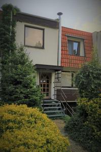 a house with stairs leading up to the front door at Apartmán Absolon in Blansko
