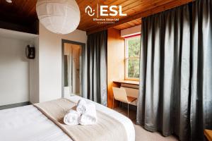 a bedroom with a bed with two pairs of shoes on it at 3 Bedroom House - Overlooking River - Shrewsbury Town Centre in Shrewsbury