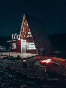 a house with a fire pit in front of it at night at Refúgio Fortaleza - Cabana Amora in Cambara do Sul