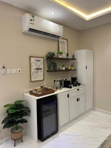 a kitchen with a sink and a stove top oven at شقة مودرن في حي العقيق in Riyadh