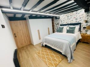 a bedroom with a large bed and a wooden floor at Apartamento Magdalena 2 in Oviedo