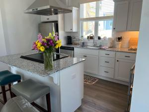 a kitchen with a counter with a vase of flowers on it at New Centennial Park Luxury Smart Home w Courtyard in Fayetteville