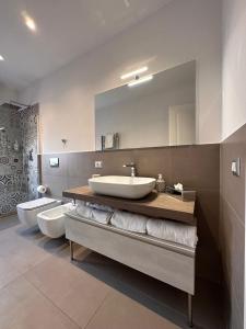 a bathroom with two sinks and a large mirror at Luxury Sea House in Trapani +70 photos