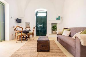 a living room with a couch and a table at The Peak House in Carovigno +22 photos