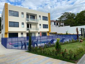 a villa with a swimming pool in front of a building at HOTEL ISIS CONFORT in La Mesa