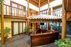 a large lobby with a large building with a bar at Haka Maori Jericoacoara in Jericoacoara