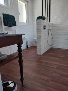 a bathroom with a toilet and a wooden floor at Suite privée in Montélimar