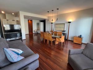 a living room with a couch and a dining room at Home of Neptune in Póvoa de Varzim