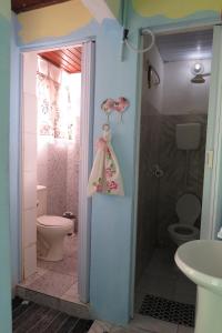 a bathroom with a toilet and a shower and a sink at AXÉ HOME Martha & Jorge in Salvador