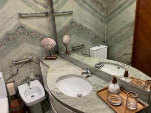 a bathroom with a sink and a toilet at Home of Neptune in Póvoa de Varzim +4 photos