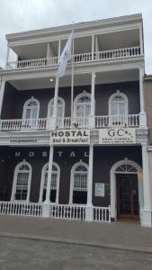 a historic building with a flag in front of it at Gran Casona Hostal in Iquique