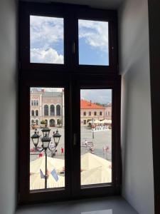a window with a view of a city seen through it at Apartamenty Rynek 18 in Żywiec
